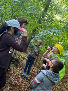 Schüler und Lehrkraft im Wald